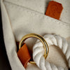 Close-up of brass, leather and cotton rope detail on vintage-inspired design for tough yet elegant ditty bag.